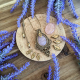 Handcrafted macramé pendant with a Rosa Quartz gemstone centerpiece and brass details, perfect as a gift from a small business for hippie, and wellbeing-focused clients.