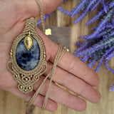 Handcrafted macramé pendant with a Sodalite gemstone centerpiece and brass details, perfect as a gift from a small business for hippie, and wellbeing-focused clients.