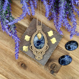 Handcrafted macramé pendant with a Sodalite gemstone centerpiece and brass details, perfect as a gift from a small business for hippie, and wellbeing-focused clients.